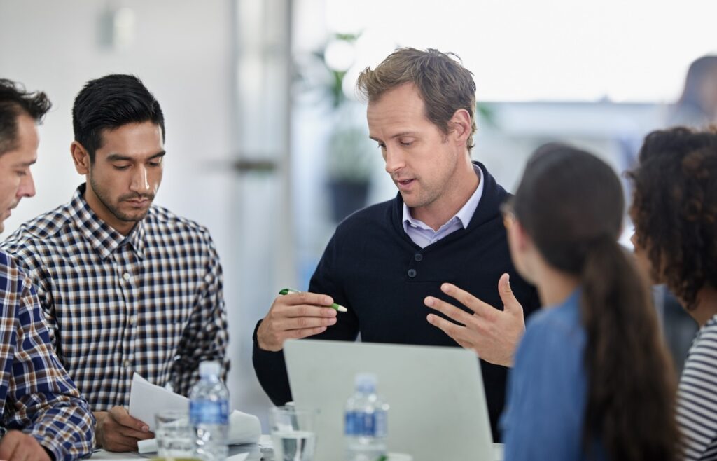 employees discussing cyber risk assessments