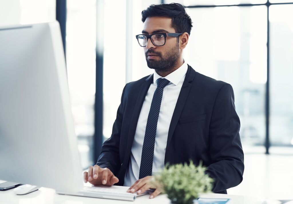 employee working on nist compliance on computer