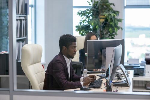 man working on computer in office with support from IT provider